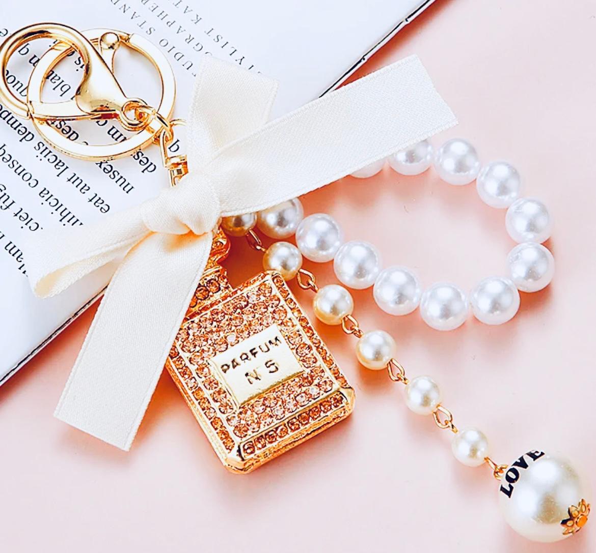 Beige Bow Knot Perfume Bottle Metal Keychain.